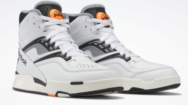 View of white and black Reebok shoes.